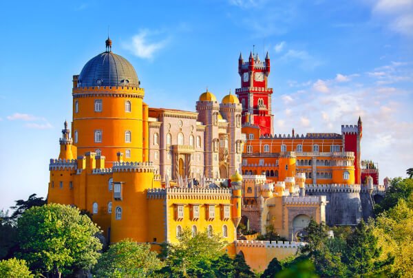 Palace of Pena in Sintra. Lisbon, Portugal. Famous landmark. Summer morning landscape with blue sky.